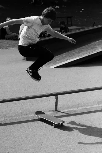 skateboarder doing hippie jump over obstacle