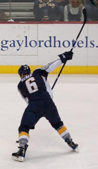 picture of hockey player beginning the slapshot