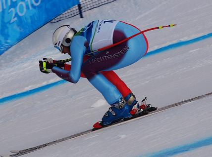 downhill skier in a crouch position to minimize drag