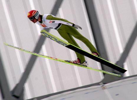 picture of ski jumper making v shape with his skis